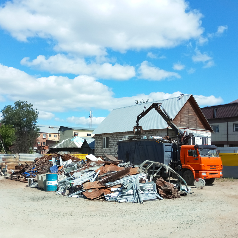 a truck picking up scrap metal